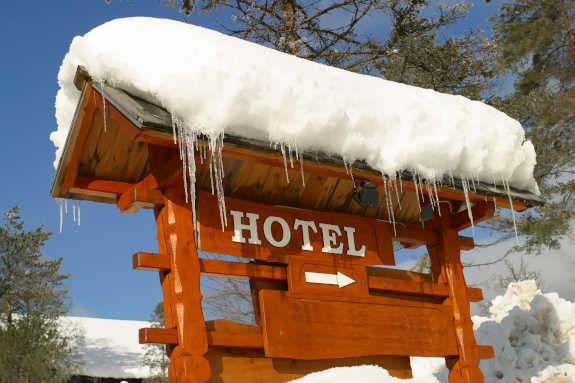 ski hotel sign covered in snow