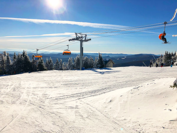 top of omeko mountain in vermont with ski lift and sunshine